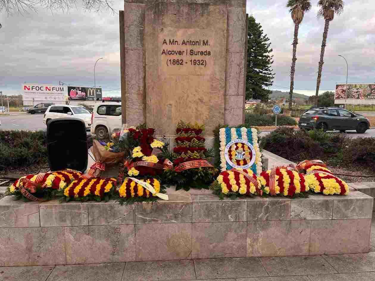 El Obelisco de Mossèn Alcover en Na Camel·la rodeado de coronas de flores durante el homenaje