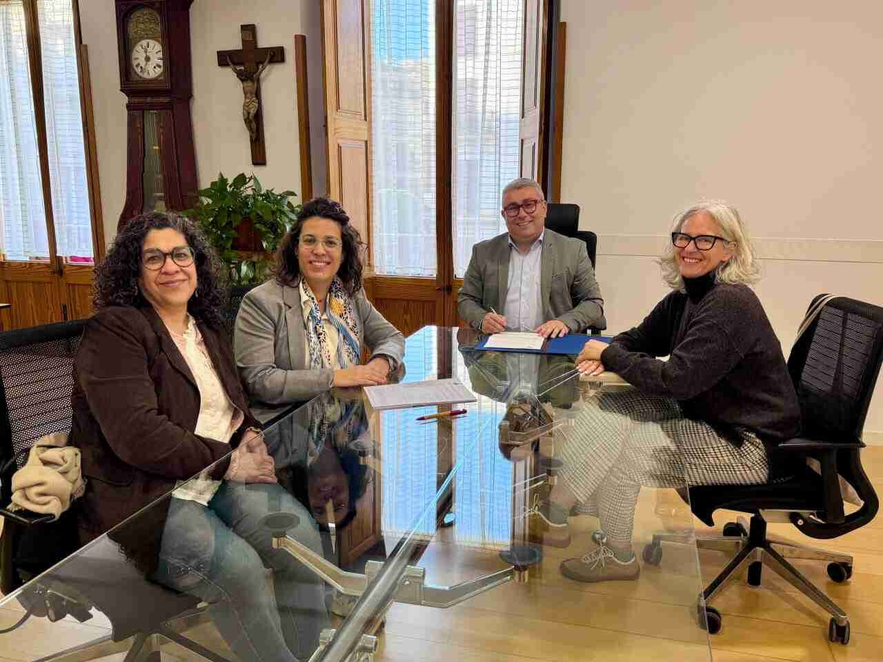 Representantes del Ayuntamiento de Inca y del Coro de Mujeres de Sant Francesc sentados en una mesa durante la firma del convenio