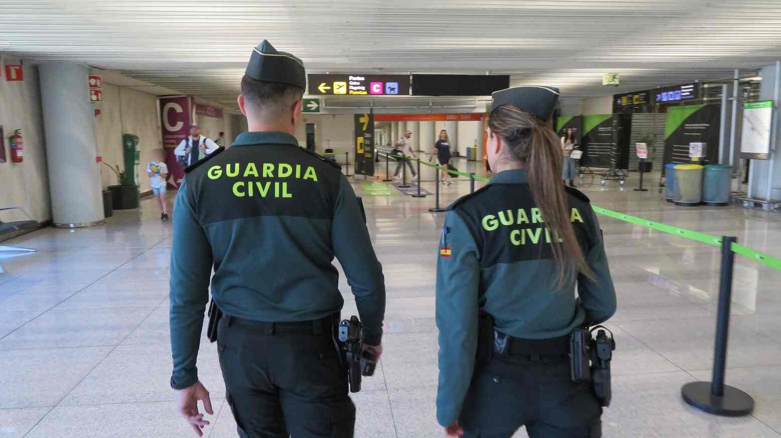 Dos agentes de la Guardia Civil caminando por el interior de la terminal del aeropuerto de Son Sant Joan