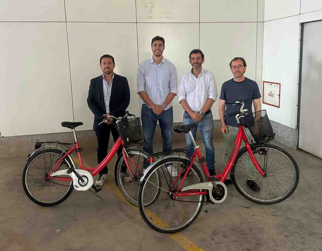 El alcalde Jaume Soler junto a representantes institucionales y del Consorcio de Transportes posando al lado de dos bicicletas rojas de paseo