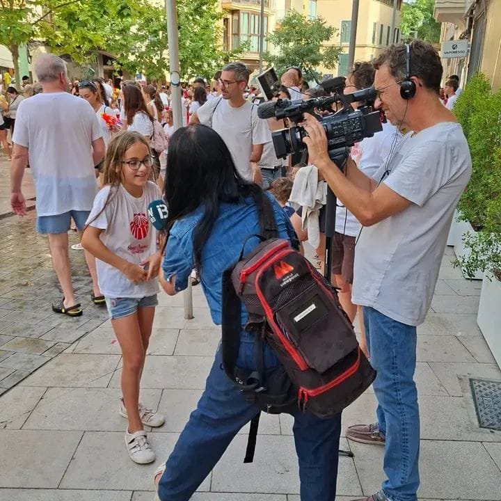 Una reportera de televisión entrevista con micrófono a Neus Llodrà, la niña de 10 años que ganó el pal ensabonat