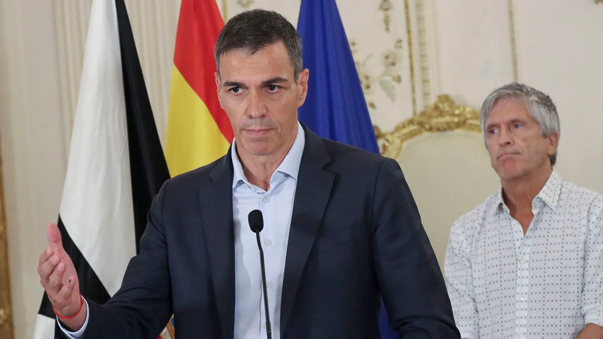 Pedro Sánchez en el atril con Fernando Grande-Marlaska al fondo durante una rueda de prensa
