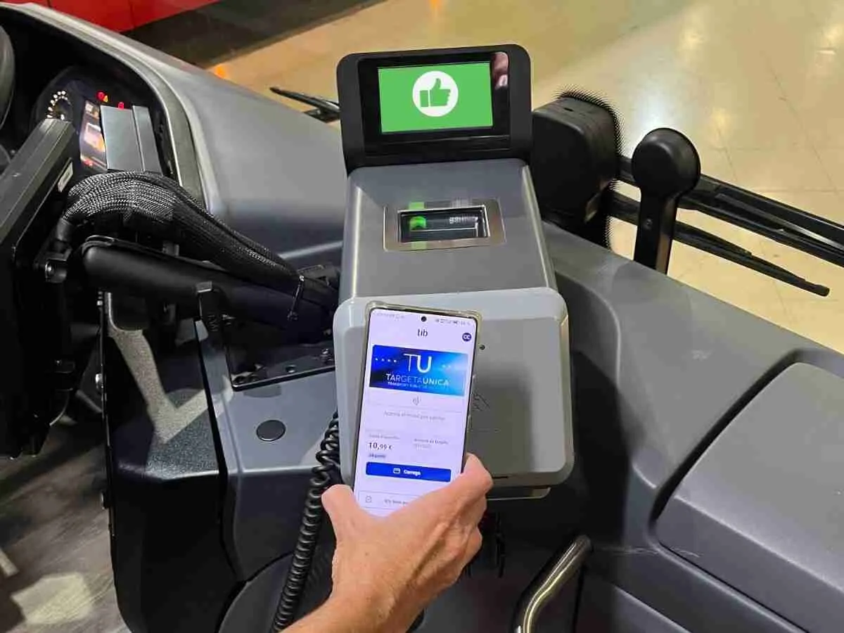 Pasajero validando la Tarjeta Única virtual desde su teléfono móvil en el lector de un autobús del TIB